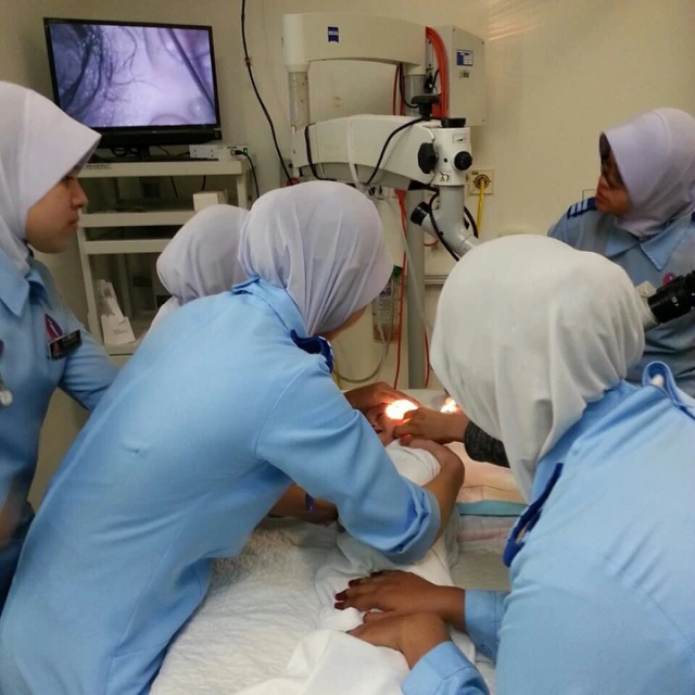 a group of medical people performing  on a girl