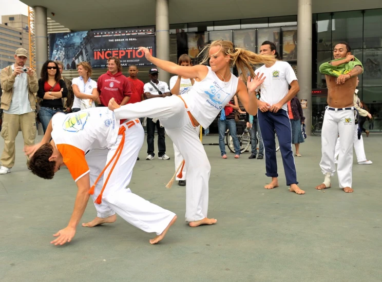 two people performing martial moves in front of many people