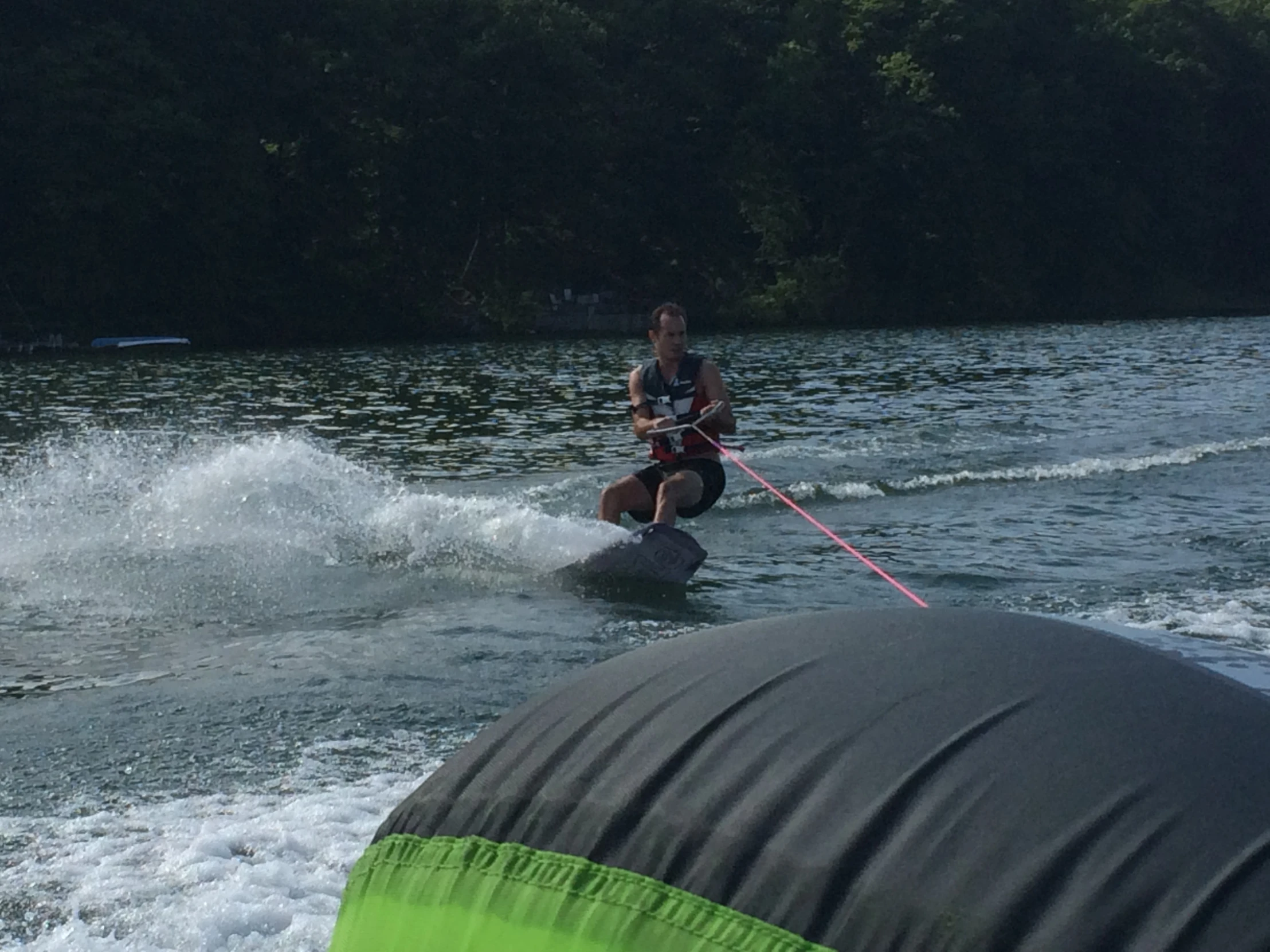 a person is on a waterboard while holding a paddle