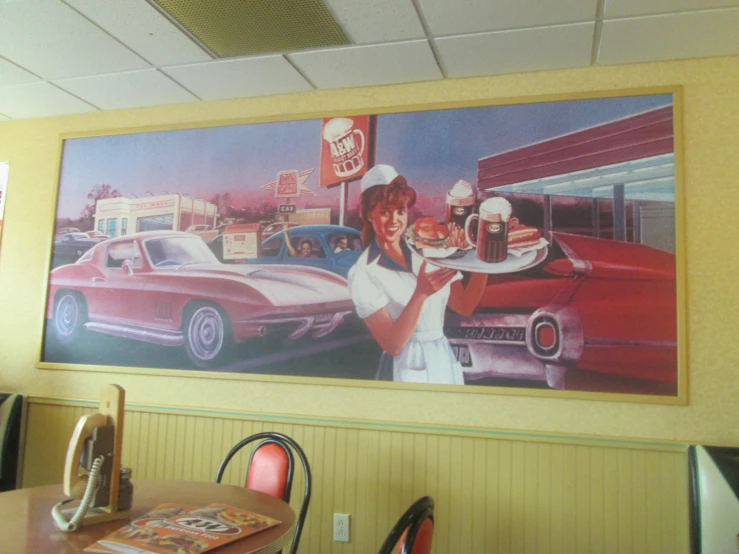 a painting hangs on the wall of a diner