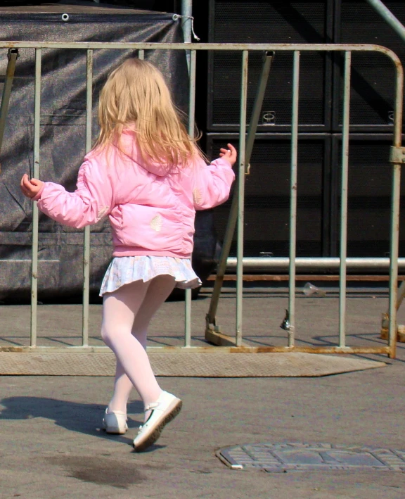 a  in pink skating on her skate board