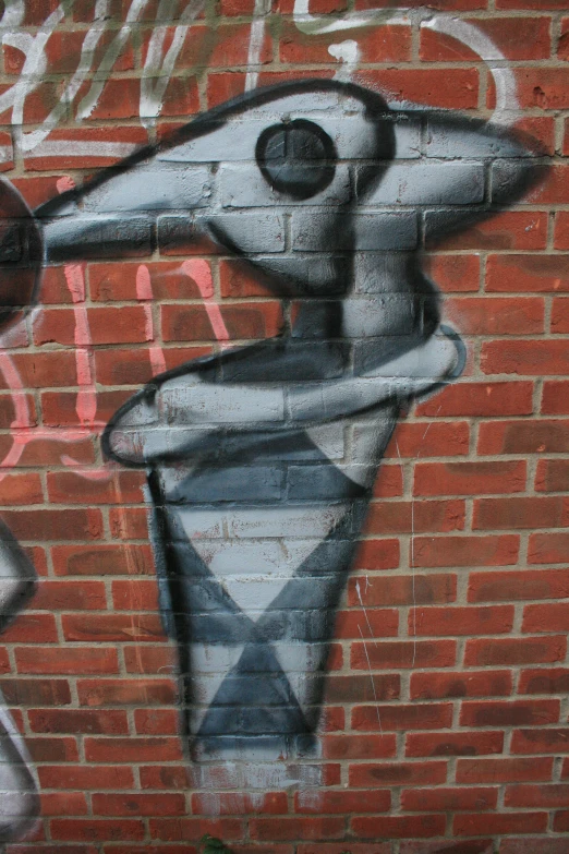 graffiti on a brick wall with an arm reaching into the air