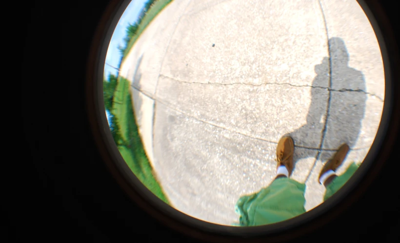 a person standing outside in front of a round window