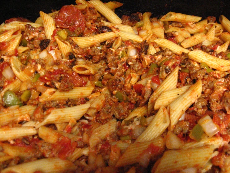 pasta, ground beef and peppers are mixed together in a pasta dish