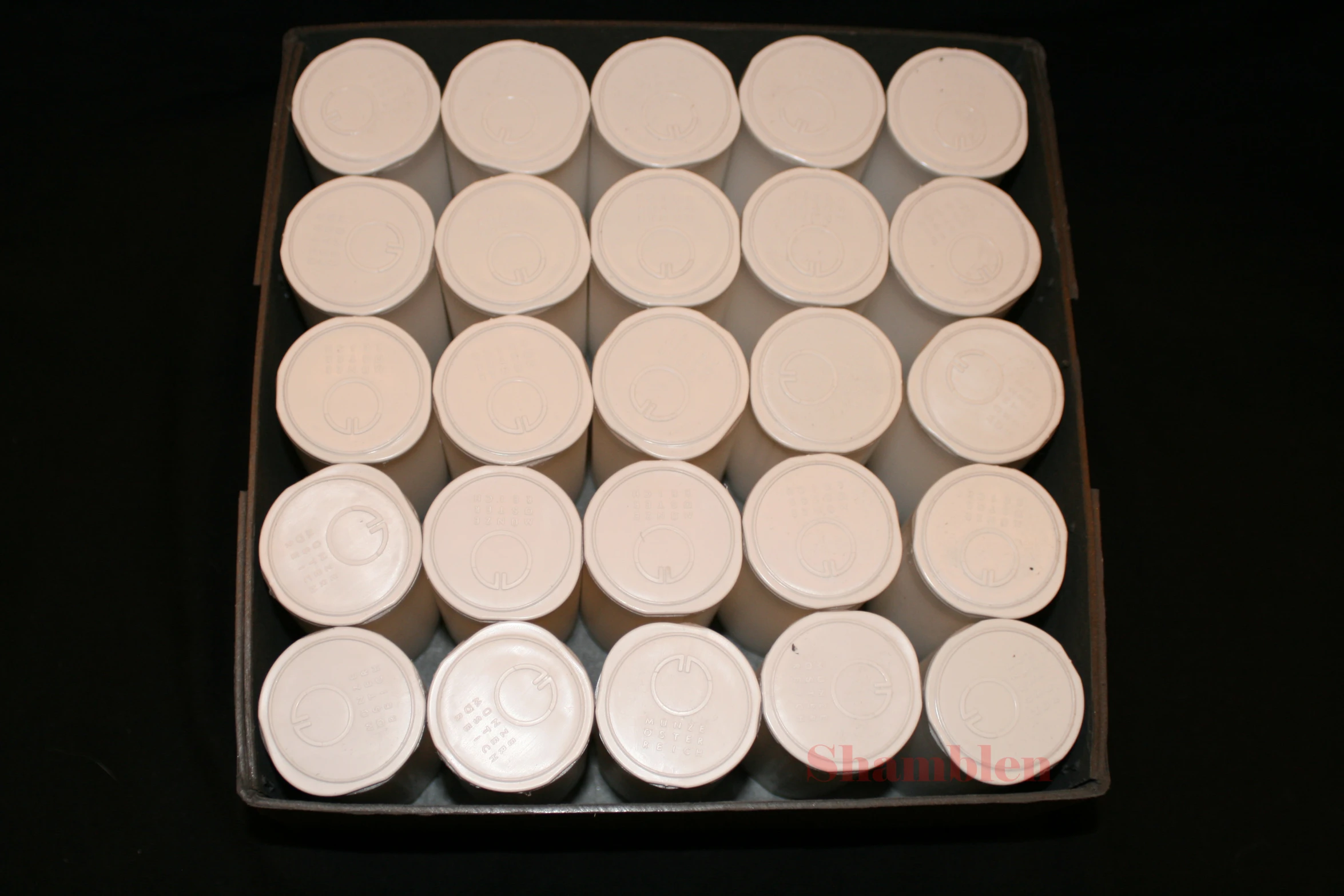 a dozen white cups with lids in a box