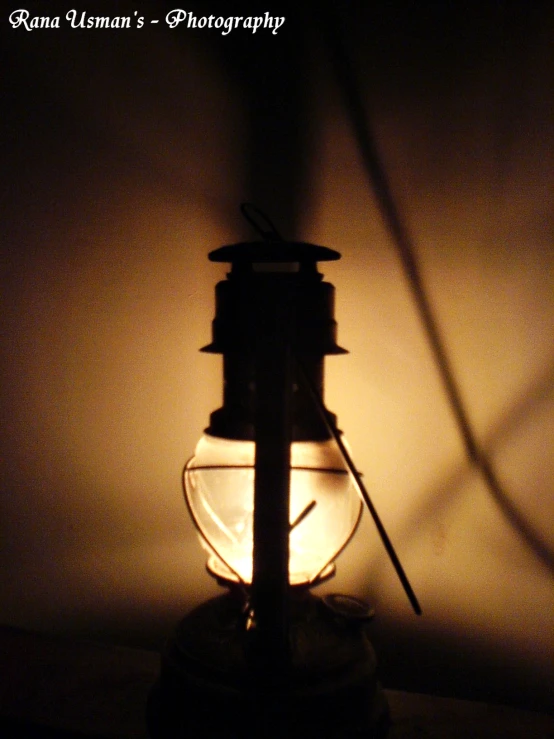 a large lamp is lit in a dark room