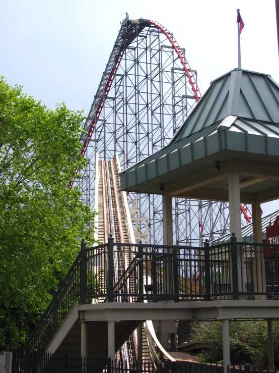 a roller coaster going up on a hill in an amut park