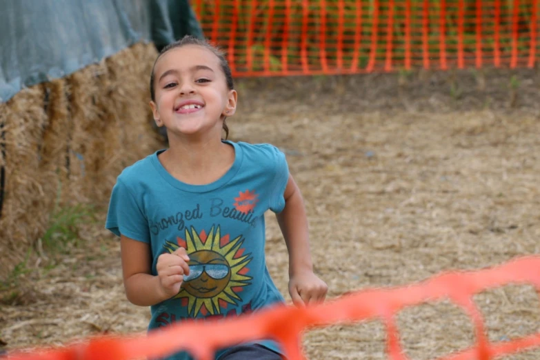  playing in obstacle ring in outdoor arena