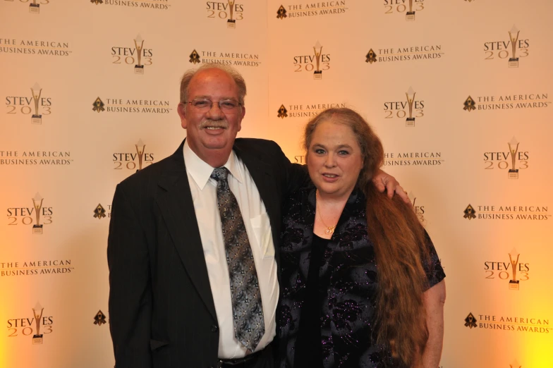 a man and woman pose together for a picture