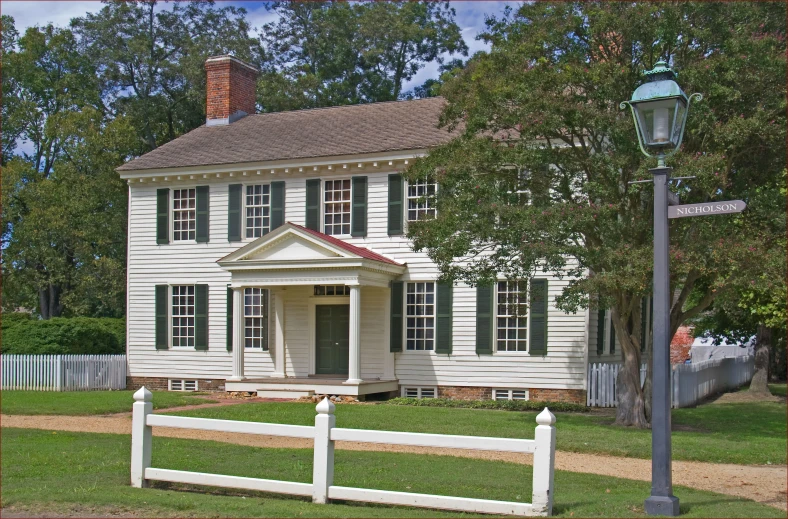 a white house sitting next to a road