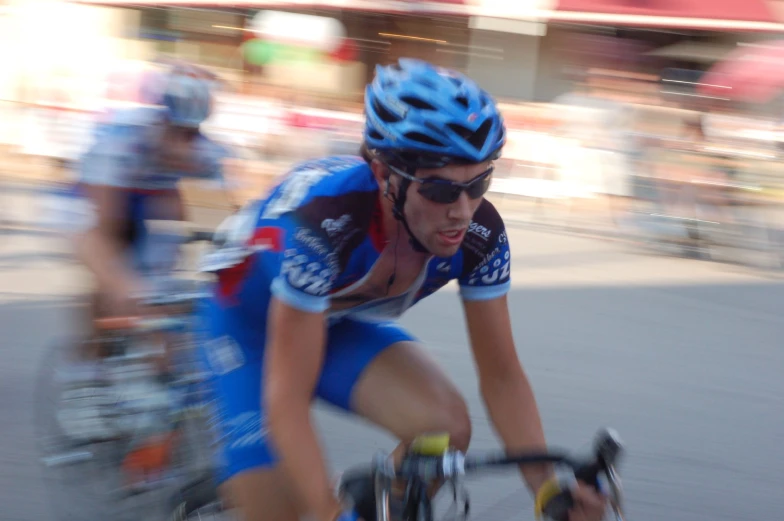 professional cyclists ride on a busy city street