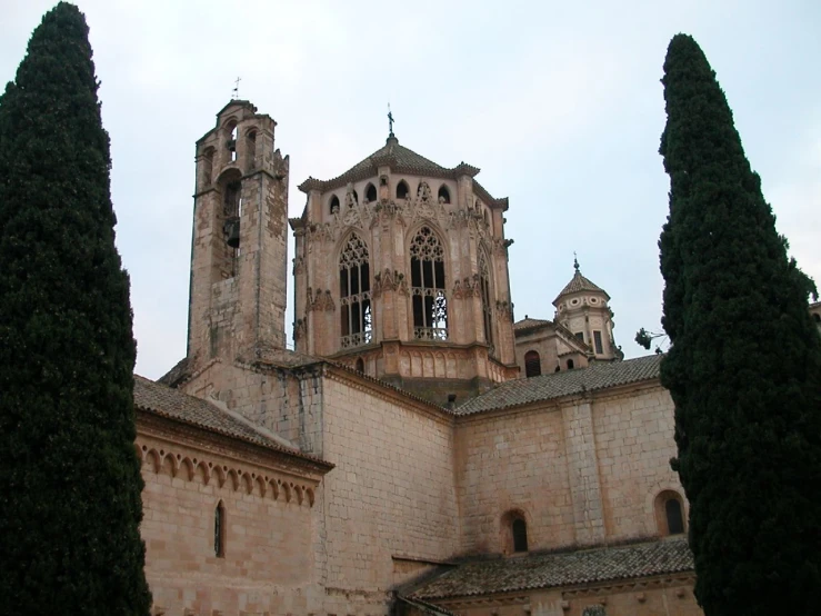 an old and beautiful building with towers and windows