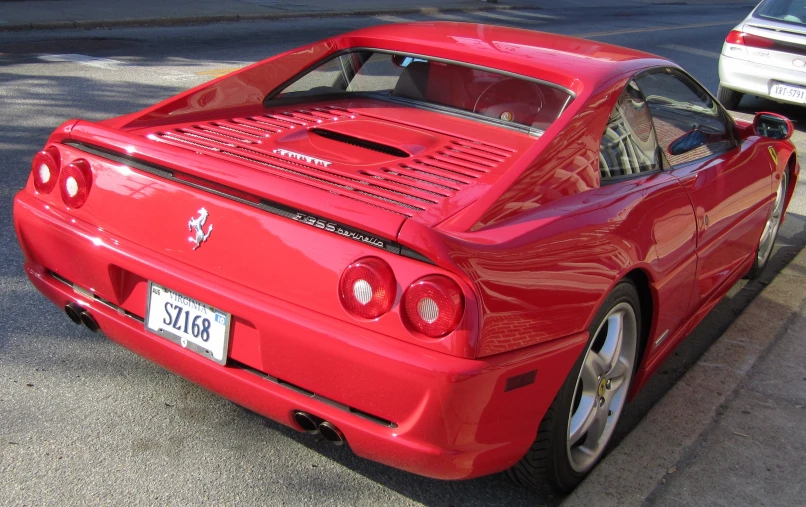 a red sports car with the number six on it's license