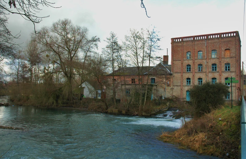 a building with a clock tower next to water