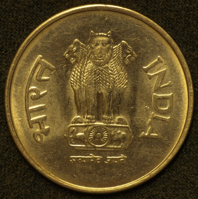 a coin on display next to a small wall