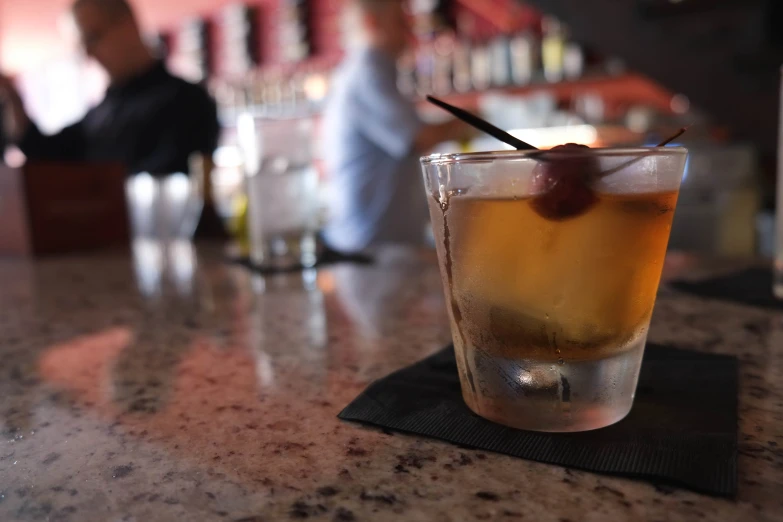 a glass of iced tea sitting on top of a table