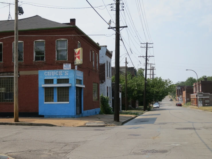 an old city street corner with blue building