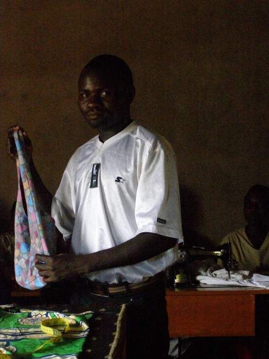 there is a man holding a colorful piece of cloth