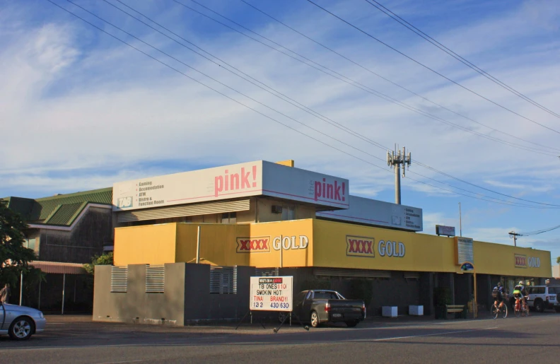 the parking lot outside a retail store has signs on it