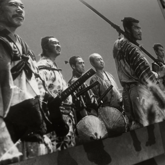 a group of men with different weapons and hats