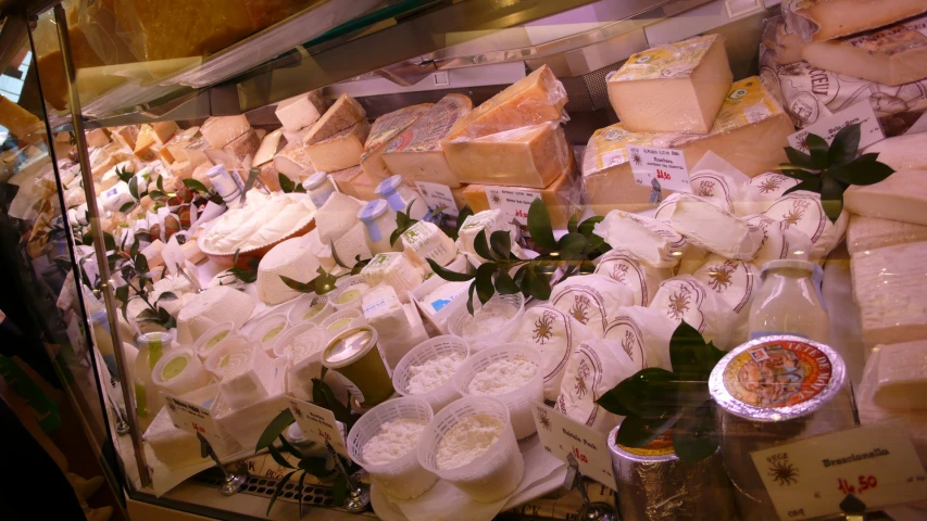 an assortment of different types of cheese on display