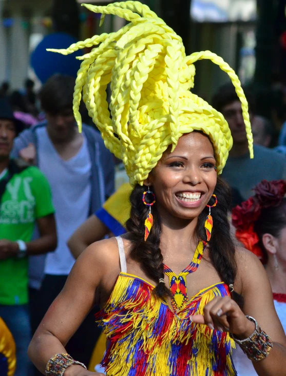 a woman is smiling as she wears an ornate hat