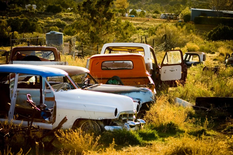 there are several old trucks parked in the field