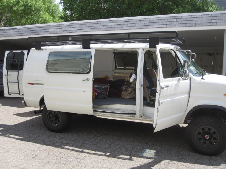 an automobile with a bed and storage on it