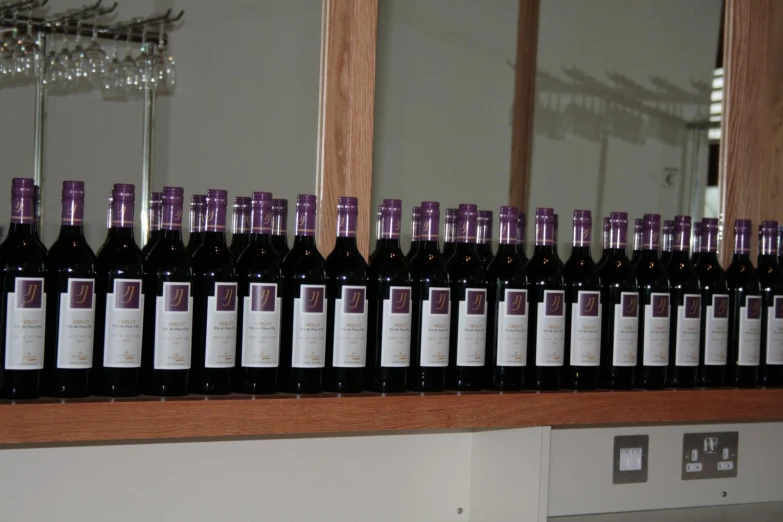 a close up of many bottles of wine on a shelf