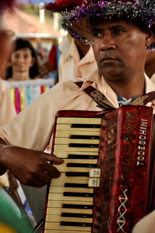 man with mexican theme hat plays an accord