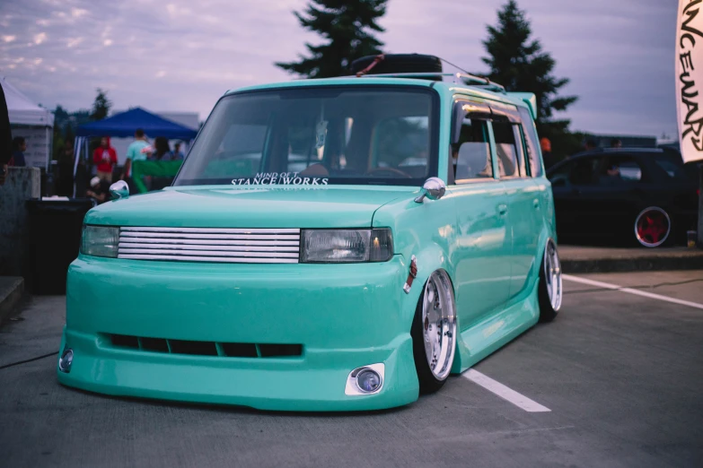 a very shiny green car with a big grill