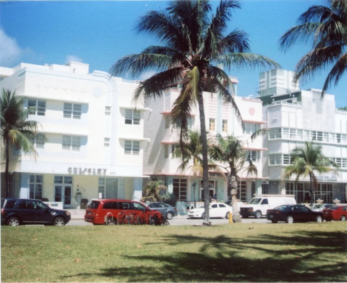 an old po of an apartment building near the grass