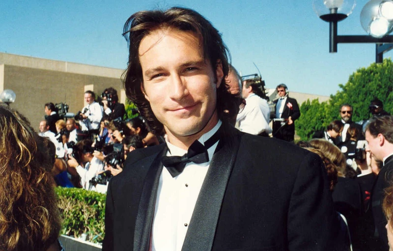 a man wearing a suit and bow tie at an event