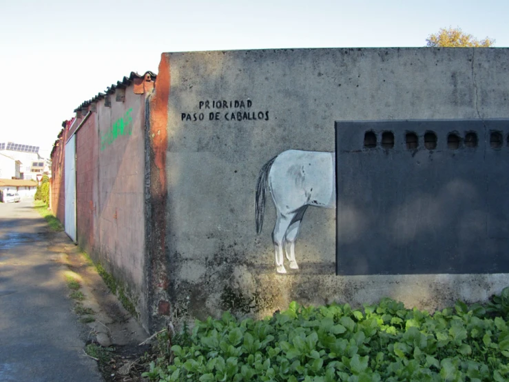 a wall with a white horse painted on it