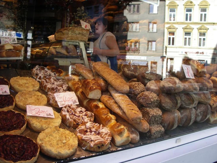 a store front window with breads and pastries on display