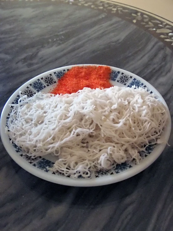 some noodles are in a blue and white bowl