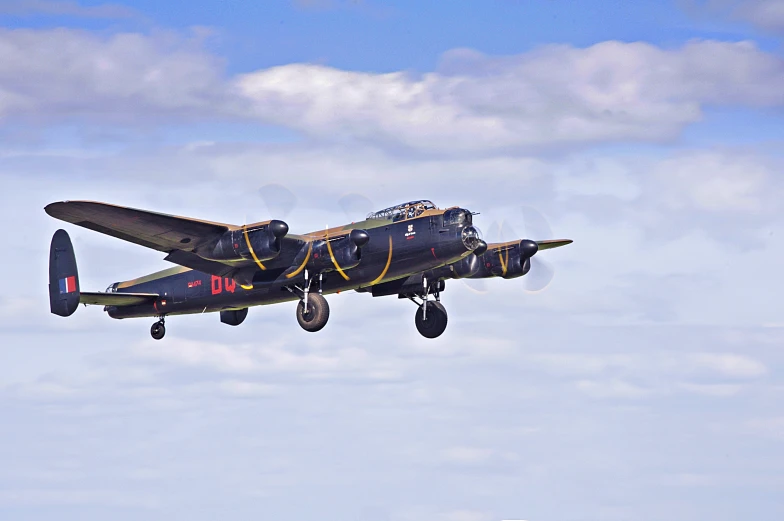 a black airplane is flying through the air