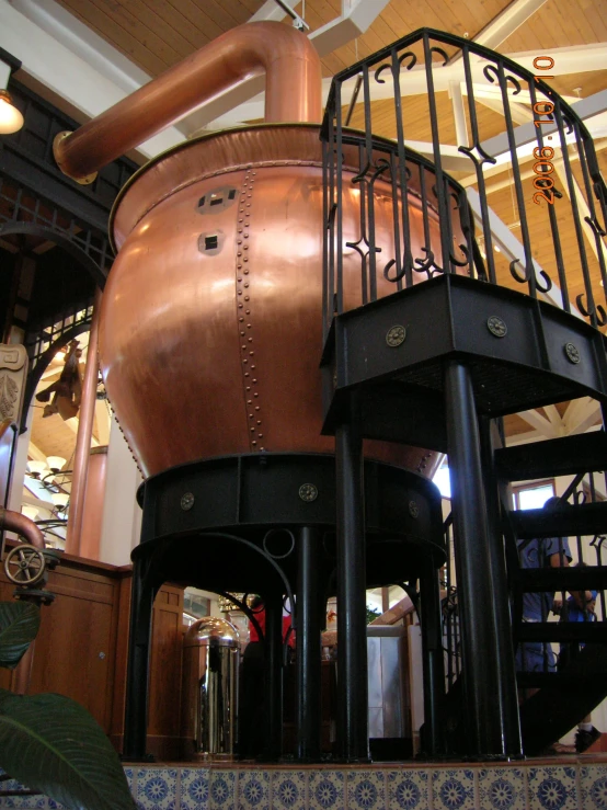 some big metal pots sitting next to a stair case