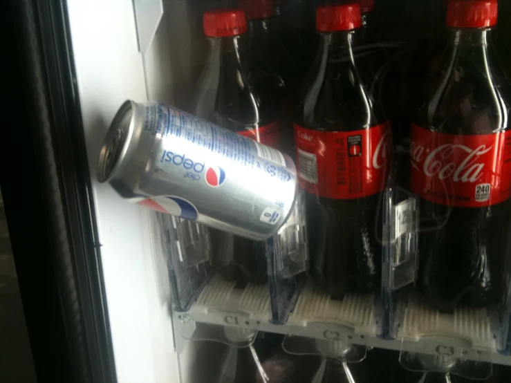 a fridge filled with bottles of soda and water