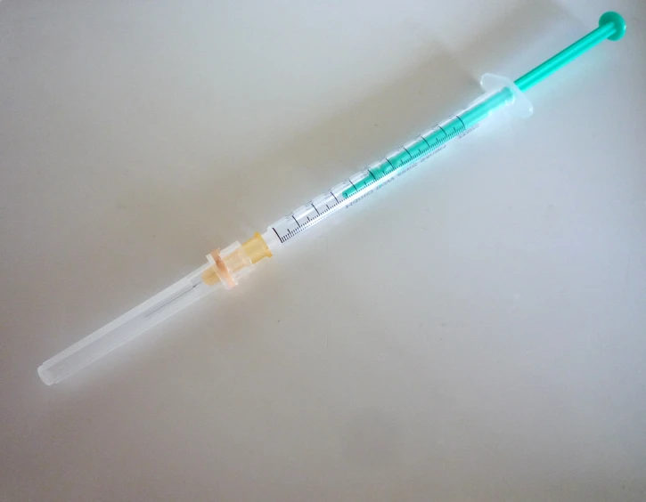 a small tube containing a needle for an iv
