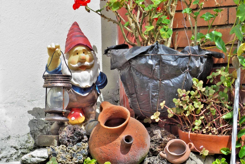 a potted plant with gnomes on it and another set of statues