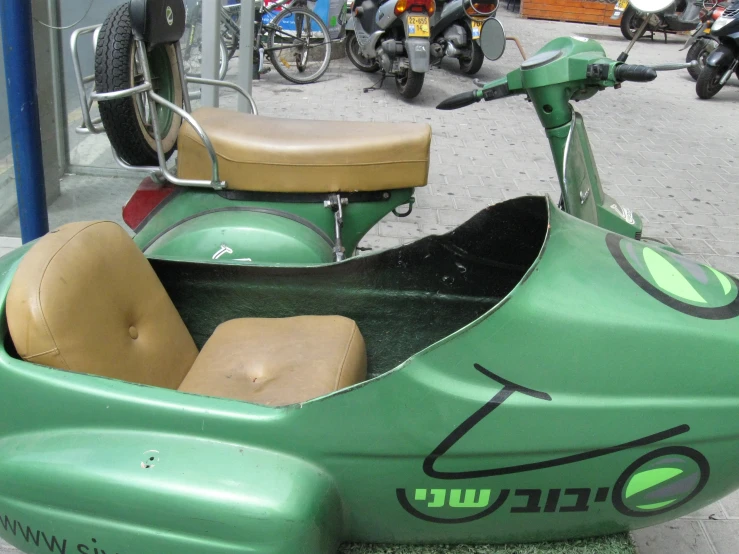 an old scooter with seats and side car sits on the sidewalk