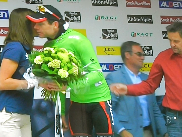 the cyclist is getting flowers from someone else