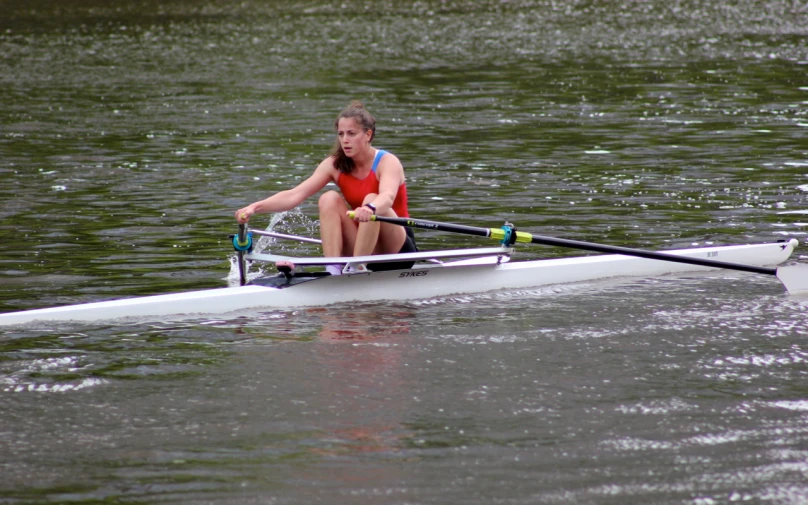 a girl rowing her boat on the river