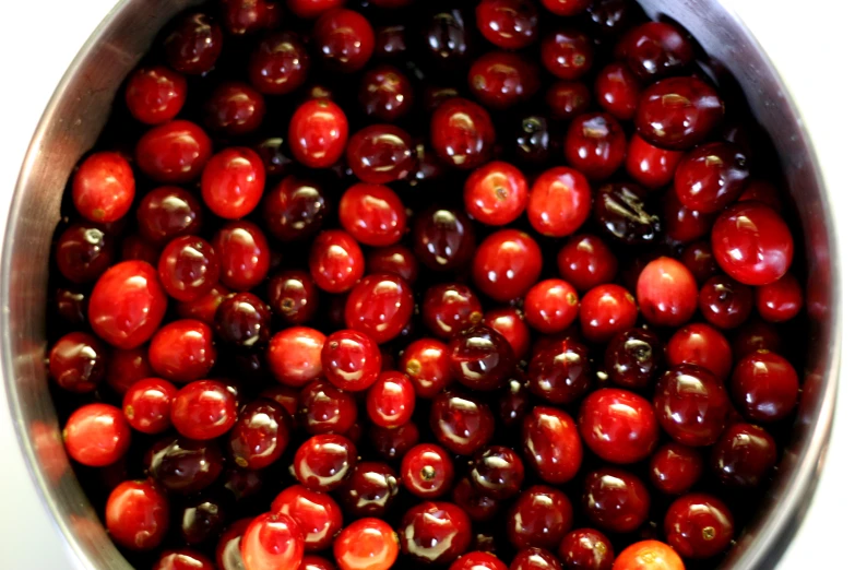 some cherries are mixed together in a pan