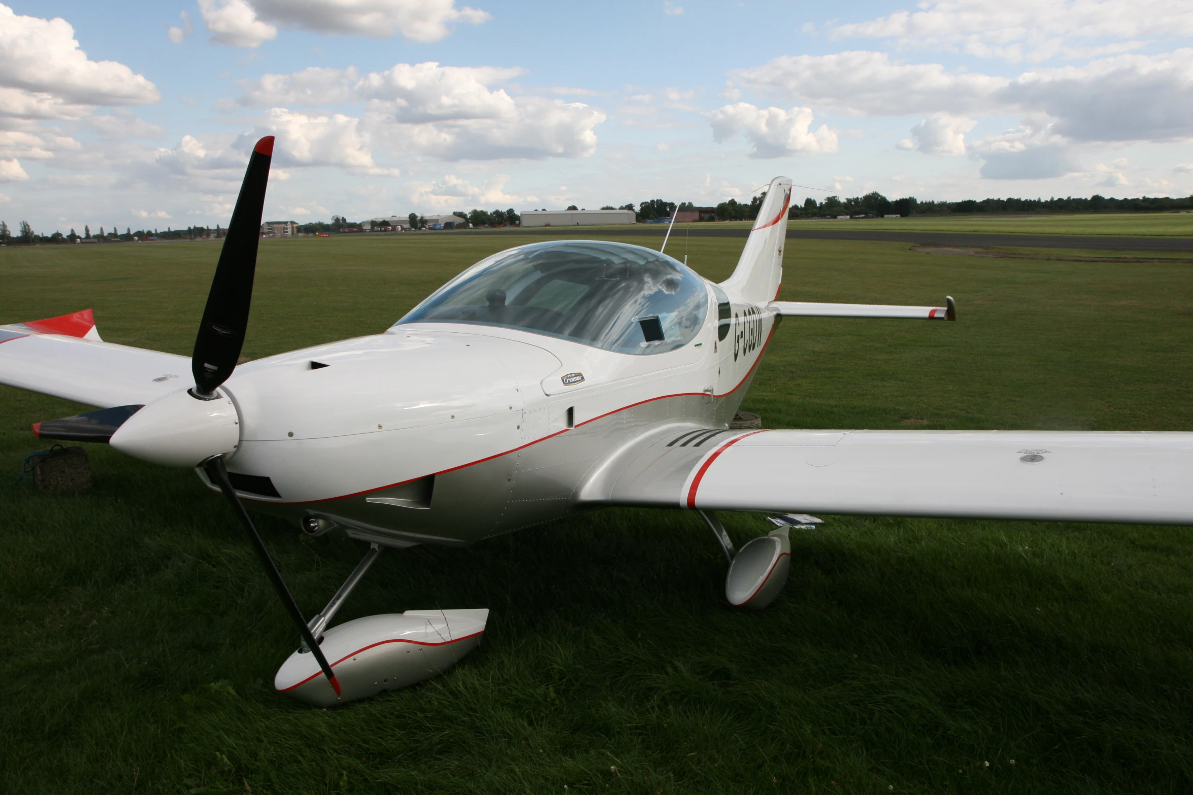 the small airplane is parked in the green grass