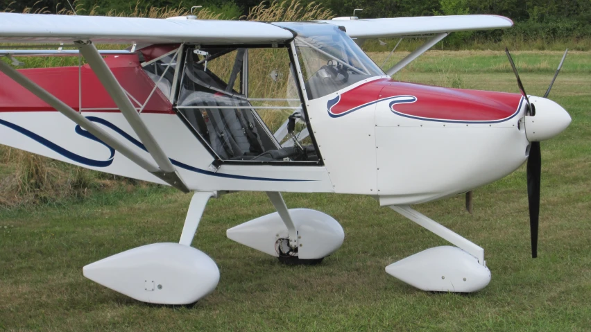 small aircraft that is sitting on the ground