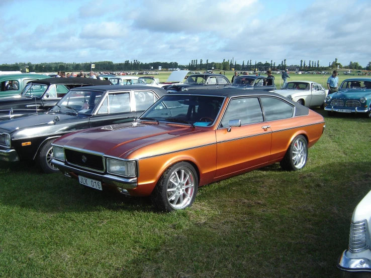 two cars parked side by side on grass