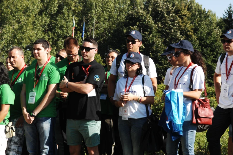 a large group of people in front of a forest