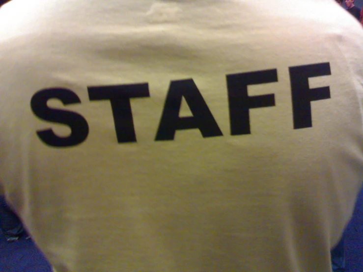 a yellow shirt with the word staff printed on it